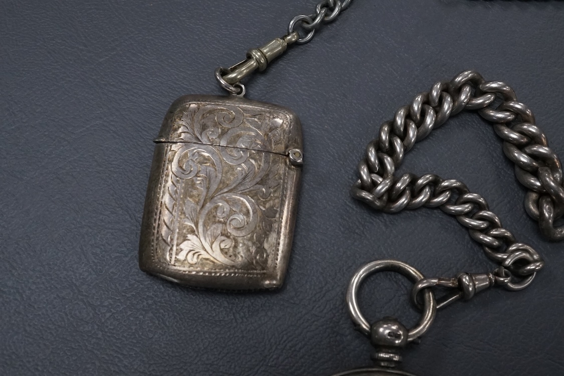 A late Victorian silver open faced key wind pocket watch, with Roman dial and subsidiary seconds, case diameter 52mm, on a heavy silver curb link albert, hung with a silver vesta case and a watch key, together with a con